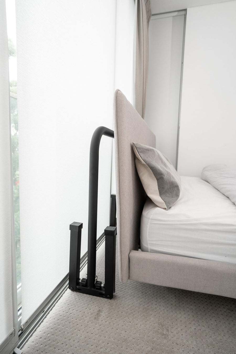 Compact dip bars stored beside a bed